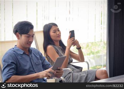 beautiful young asian business woman using smartphone in office, selective focus