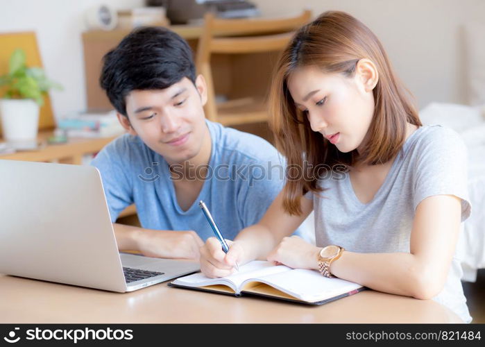 Beautiful young asian couple calculate expenses finance with laptop and planning together, woman writing notebook or note budget household, lifestyle family and business concept.
