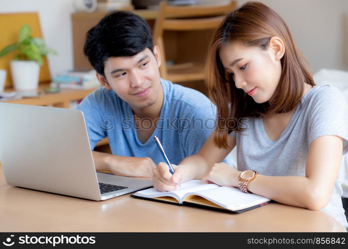 Beautiful young asian couple calculate expenses finance with laptop and planning together, woman writing notebook or note budget household, lifestyle family and business concept.