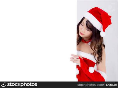 Beautiful young asian Santa woman holding blank board for xmas isolated on white background, beauty model asia girl show empty banner paper poster in Christmas holiday and new year for advertisement.
