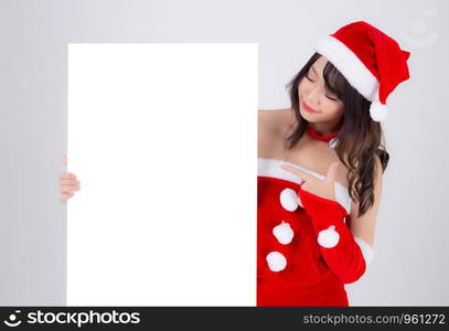 Beautiful young asian Santa woman holding blank board for xmas isolated on white background, asia girl show empty banner paper poster and pointing in Christmas holiday and new year for advertisement.