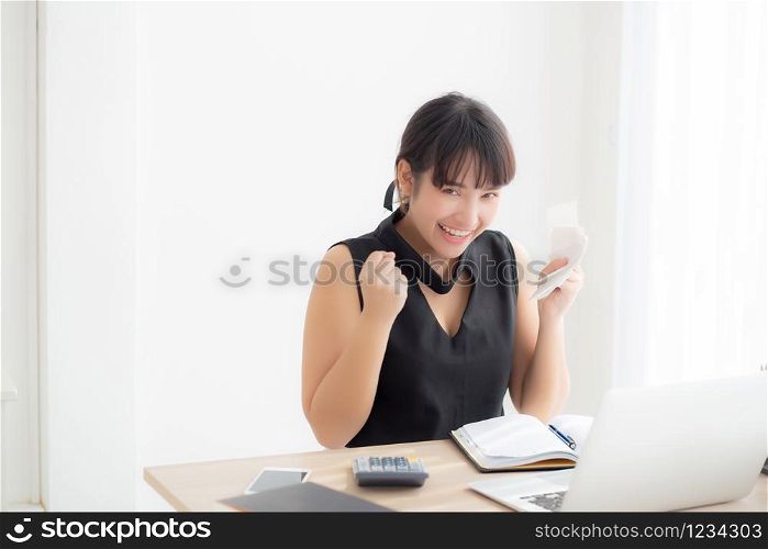 Beautiful young asian woman calculating finance household and writing notebook on desk, girl checking bill and success for saving expenses household with target, debt closure, business concept.