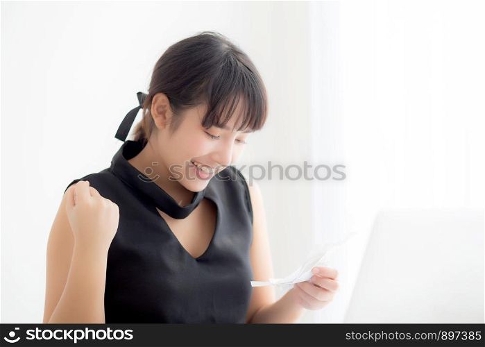 Beautiful young asian woman calculating finance household and writing notebook on desk, girl checking bill and success for saving expenses household with target, debt closure, business concept.