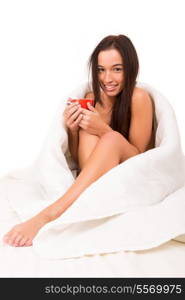 Beautiful young asian woman holding a cup of tea or coffee in bed