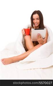 Beautiful young asian woman holding a cup of tea or coffee in bed