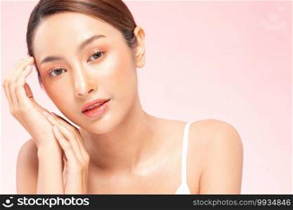 Beautiful Young Asian Woman Holding Hands smile feeling so happy and cheerful with healthy Clean and Fresh skin,isolated on PINK background,Beauty Cosmetology and spa treatment Concept