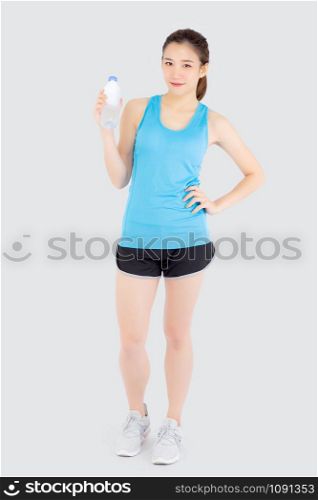 Beautiful young asian woman in sport after workout drinking water from bottle for thirsty isolated on white background, asia girl after exercise drink water for hydration and refresh with healthy.