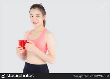 Beautiful young asian woman in sport after workout drinking water from glass for thirsty isolated on white background, girl after exercise drink coffee or tea for hydration and refresh with healthy.