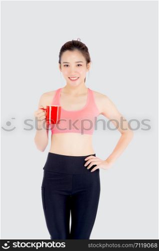 Beautiful young asian woman in sport after workout drinking water from glass for thirsty isolated on white background, girl after exercise drink coffee or tea for hydration and refresh with healthy.