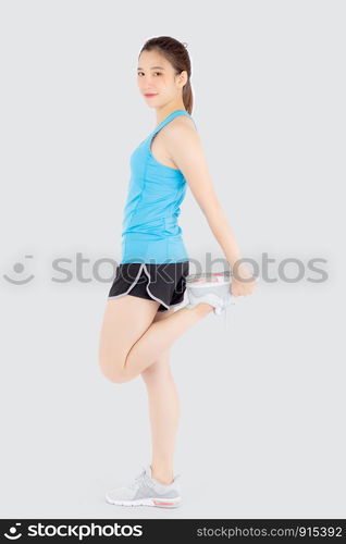 Beautiful young asian woman in sport standing stretch muscle leg exercise with healthy isolated on white background, asia girl shape fit warm up and workout training for healthy, wellness concept.