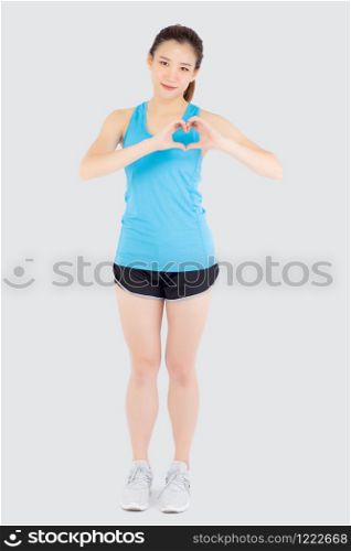Beautiful young asian woman in sport with healthy gesture heart shape with hand isolated on white background, asia girl showing heart symbol, exercise with cardio for health and wellbeing concept.