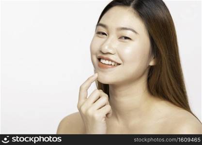 Beautiful Young Asian Woman Looking While Touching Chin feeling so happy and cheerful with healthy Clean and Fresh skin,isolated on white background,Beauty Cosmetology Concept