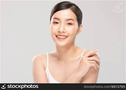 Beautiful Young Asian Woman Looking While Touching Shoulder feeling so happy and cheerful with healthy Clean and Fresh skin,isolated on white background,Beauty Cosmetology Concept