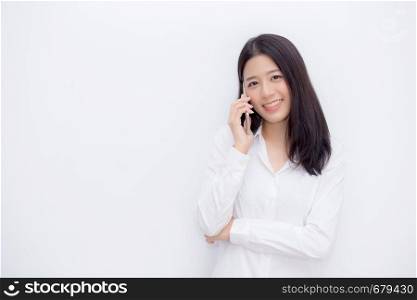 Beautiful young asian woman talking mobile phone and smile standing on cement background, freelancer female calling telephone, communication concept.
