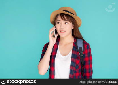 Beautiful young asian woman talking smart mobile phone in vacation isolated on blue background, asia girl conversation on smartphone in travel summer trip, journey and communication concept.