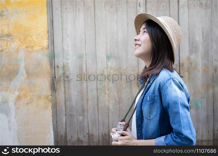 Beautiful Young Asian woman tourist walking in old city area of Bangkok Thailand. Solo travel concept in the holiday