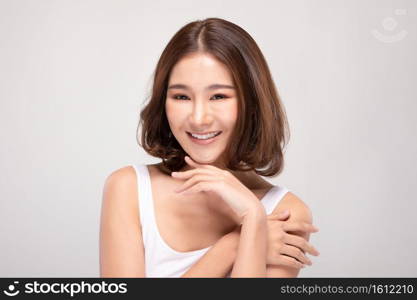 Beautiful Young Asian Woman with short hair Looking While Touching Chin feeling so happy and cheerful with healthy Clean and Fresh skin,isolated on white background,Beauty Cosmetics Concept