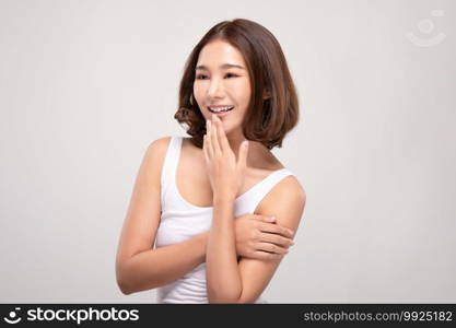 Beautiful Young Asian Woman with short hair Looking While Touching Chin feeling so happy and cheerful with healthy Clean and Fresh skin,isolated on white background,Beauty Cosmetics Concept