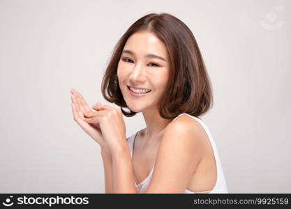 Beautiful Young Asian Woman with short hairs Holding Hands smile feeling so happy and cheerful with healthy Clean and Fresh skin,isolated on white background,Beauty Cosmetics Concept