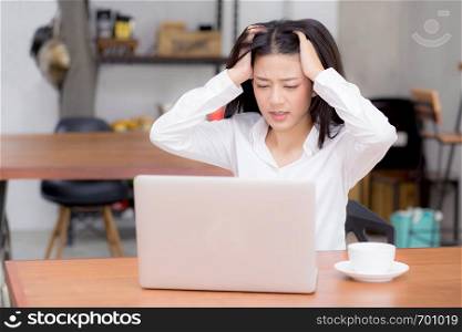 Beautiful young asian woman working and thinking with problem to stress and unhappy, businesswoman with laptop computer on table with emotion, freelance business concept.
