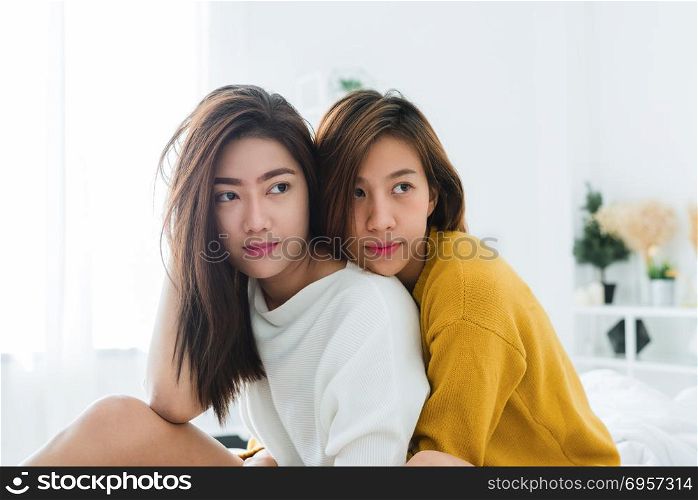 Beautiful young asian women LGBT lesbian happy couple sitting on. Beautiful young asian women LGBT lesbian happy couple sitting on bed hugging and smiling together in bedroom at home. LGBT lesbian couple together indoors concept. Spending nice time at home.