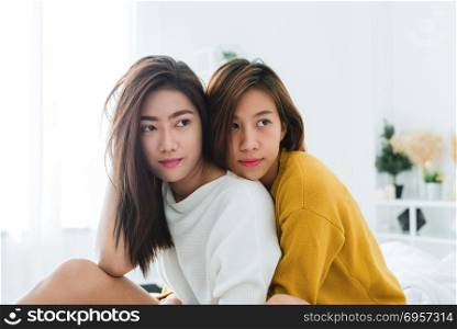 Beautiful young asian women LGBT lesbian happy couple sitting on. Beautiful young asian women LGBT lesbian happy couple sitting on bed hugging and smiling together in bedroom at home. LGBT lesbian couple together indoors concept. Spending nice time at home.
