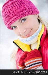 Beautiful young blond in winter forest close-up portrait