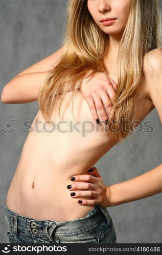 beautiful young blond woman in jeans studio shot