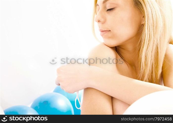 beautiful young blond woman in white and blue balloons