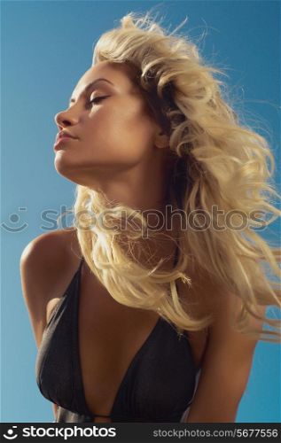 Beautiful young blond woman outdoors portrait at the sea