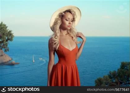Beautiful young blond woman outdoors portrait at the sea