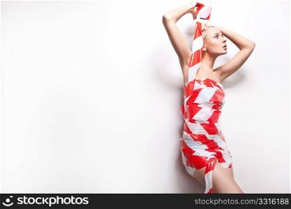 Beautiful young blond woman wrapped in warning tape