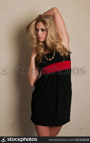 Beautiful young blonde in a black dress