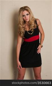 Beautiful young blonde in a black dress