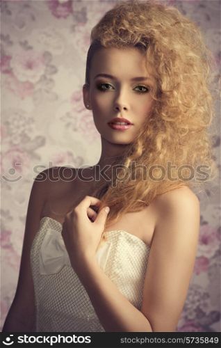 beautiful young blonde lady posing in close-up fashion shoot with creative stylish hair-style, colorful make-up and elegant white dress