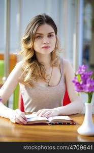 Beautiful young blonde sitting in the cafe