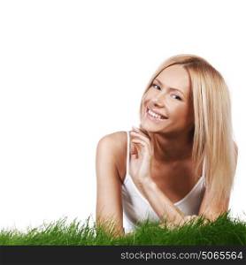 Beautiful young blonde smiling woman lying on grass, isolated on white background. Smiling woman on grass