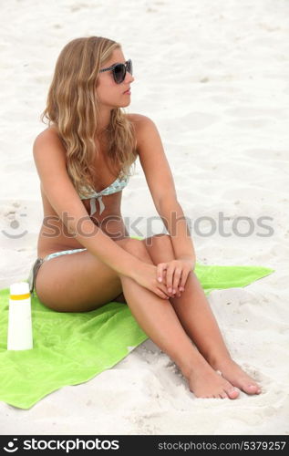 beautiful young blonde sunbathing at beach