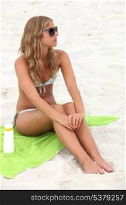 beautiful young blonde sunbathing at beach