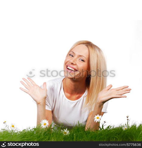 Beautiful young blonde woman lying on grass with chamomile flowers, isolated on white background