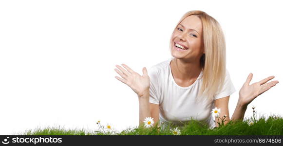 Beautiful young blonde woman lying on grass with chamomile flowers, isolated on white background. Woman on grass with flowers