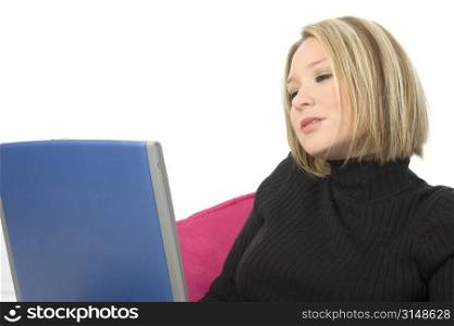 Beautiful young blonde woman working with laptop. Shot in studio.