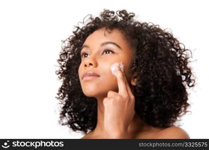 Beautiful young Brazilian woman applying massaging exfoliating anti-aging cream facial mask - skincare cosmetology - isolated.