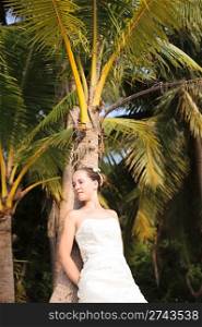 Beautiful young bride on the tropical wild beach