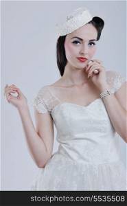 beautiful young bride wearing wedding dress in retro fashion style isolated on white background in studio