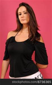 Beautiful young brunette in a black sleeveless blouse
