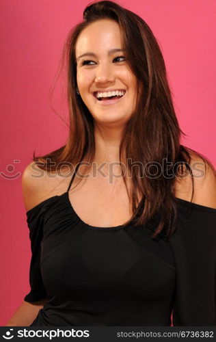 Beautiful young brunette in a black sleeveless blouse