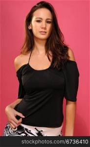 Beautiful young brunette in a black sleeveless blouse