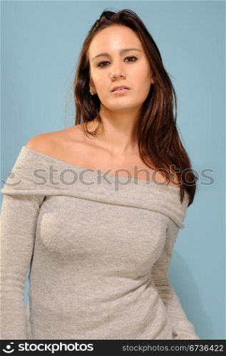 Beautiful young brunette in gray knit top
