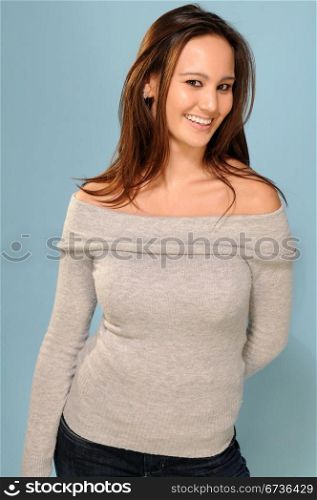 Beautiful young brunette in gray knit top